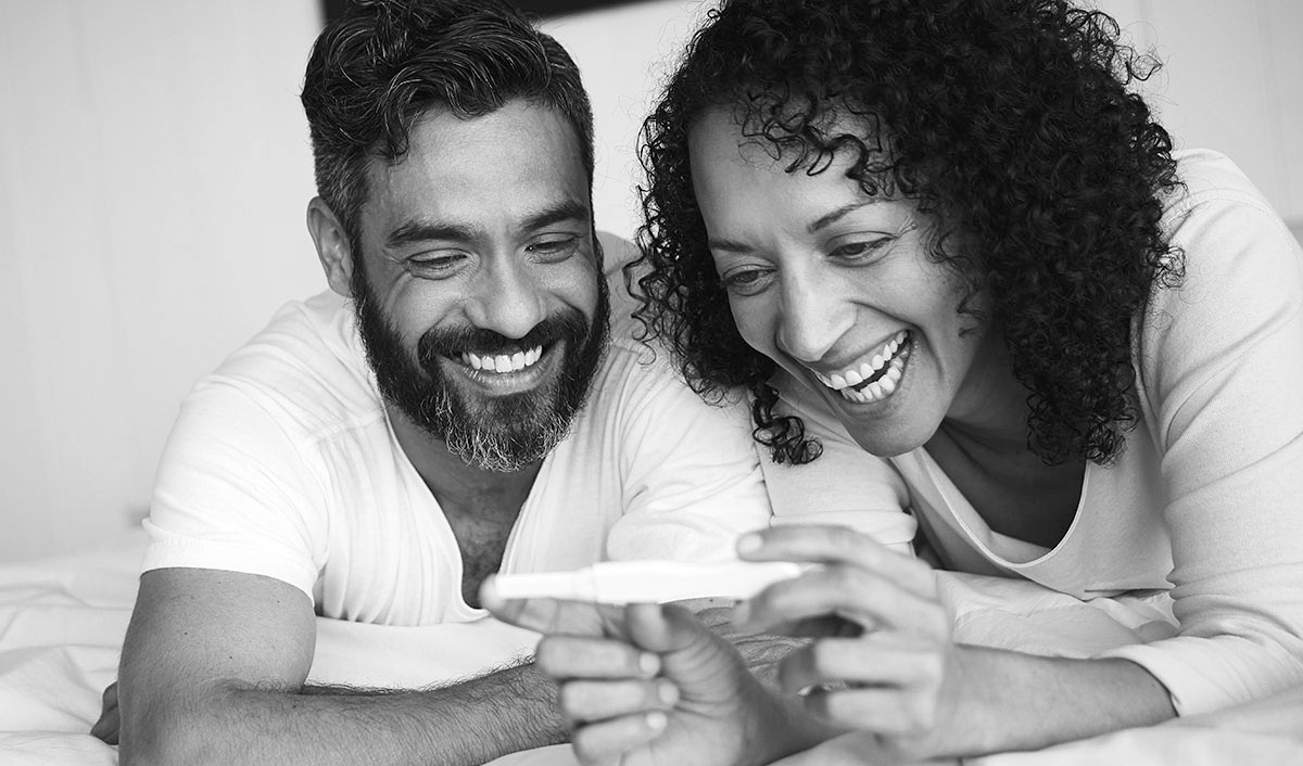 Smiling couple looking at pregnancy test