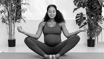 A pregnant woman meditates