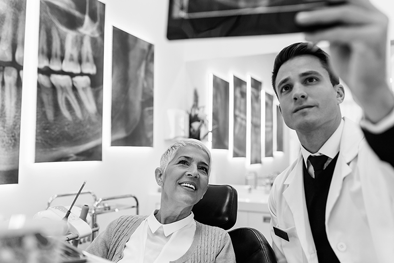 Dentist and patient reviewing x-rays