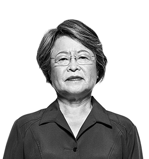 A woman with glasses and a dark collared shirt
